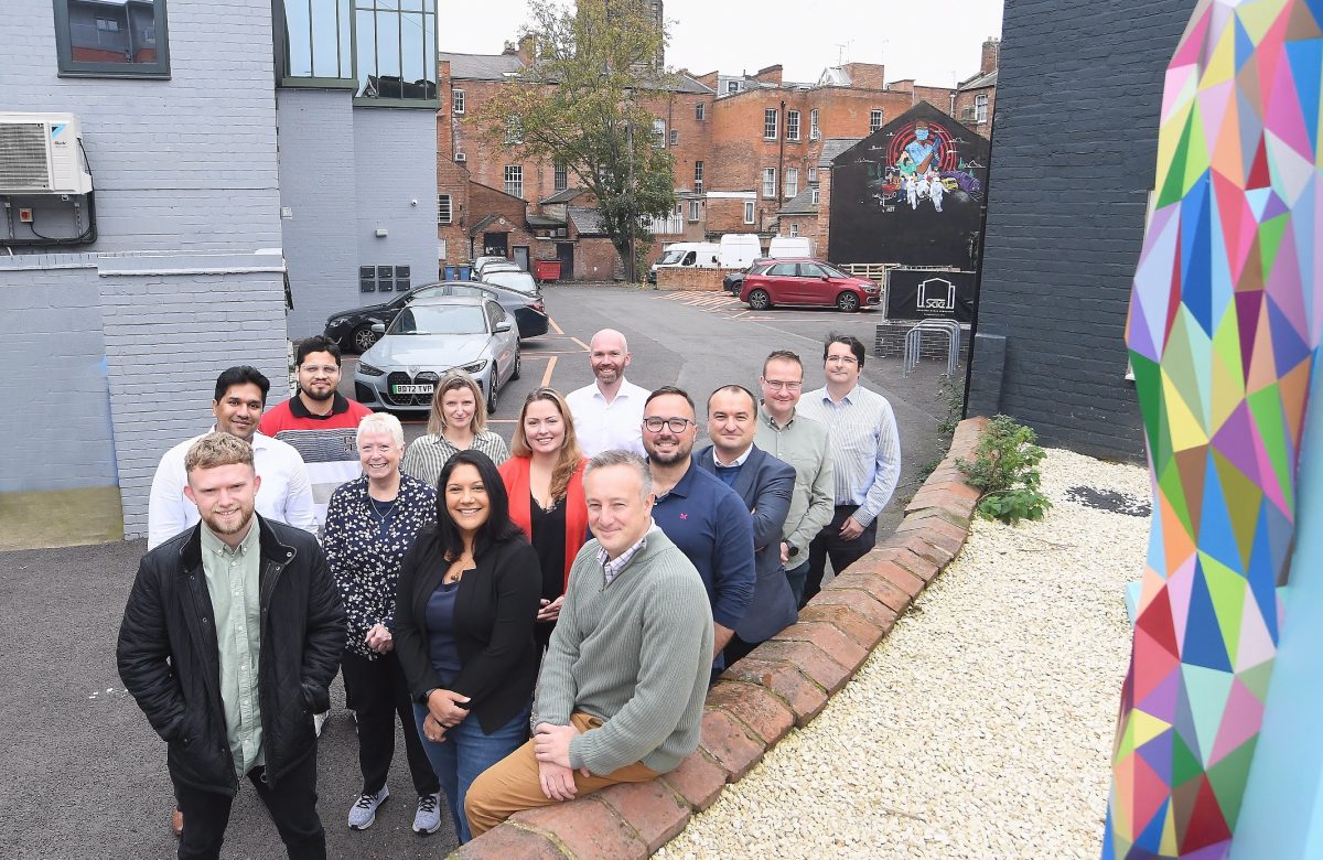 A group of business people, standing outside the recent conversion of commercial office space in Spencer Yard